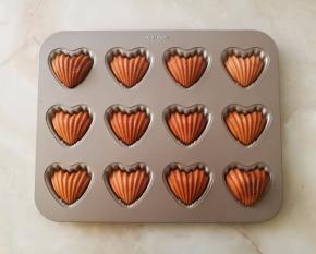 烤箱上下火180预热十分钟，预热好后模具放烤箱中层，180度烤10分钟，再转150度烤5分钟就好了，我在烤网上放了张锡纸，是为了玛德琳别上色过深了。