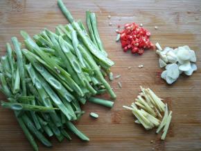 豆角从中间破开，切长条。蒜切片，姜切丝，小米椒切小段。