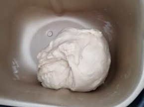 将除黄油，以外的所有材料放入面包机桶内，先转动按钮至和面程序，时间设置17分钟，当揉面剩余时间为10分钟的时候放入黄油，程序结束时检查面团，揉至扩展阶段