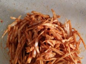 用手或者筷子混合均匀，使得每条杏鲍菇丝都均匀裹满酱料。