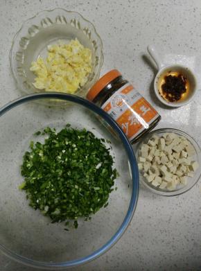 韭菜洗净切碎，鸡蛋炒熟切碎，豆腐切小块。葱切碎。