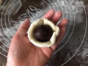 把豆沙球放在面皮中间。