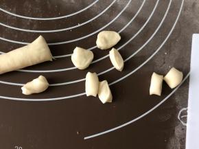 剩余的面团中掰一小块，搓成小条，切下16个约1克的小段，分别揉成小圆球。