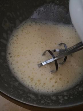 打蛋盆坐在热水里，用电动打蛋器开始打鸡蛋。