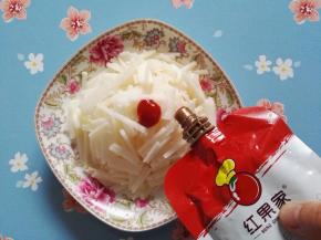 3、在凉薯丝上均匀地挤上番茄沙司，吃得时候拌匀即可。