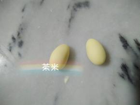 5克白面团平均分成两个，再搓成椭圆形，当小手。