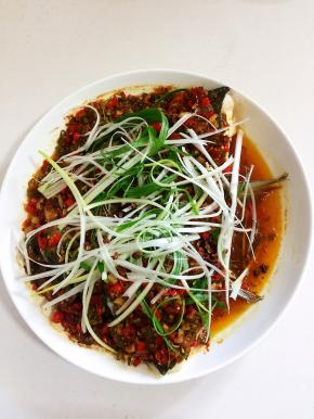 蒸好的鱼头取出来，撒上葱丝和花椒。