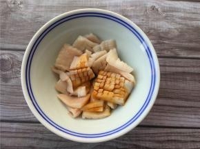 将鱿鱼切成方块花状，加入适量生抽、料酒拌匀。