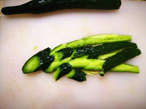 2．	黄瓜清洗干净，去根，竖着切成两半，再用刀拍几下，然后斜着切成大小适中的黄瓜块，这样黄瓜拌的时候会比较入味，