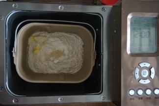 加入面包粉、黄油，在面粉顶端加入酵母，因为黄油量不多，所以可以在一开始就加入，将面包桶放入到东菱1352AE-3C面包机里