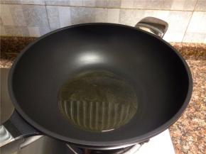 热锅倒油烧至八成热。