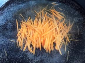 锅内烧开水，放入胡萝卜丝焯熟，捞出沥干水分