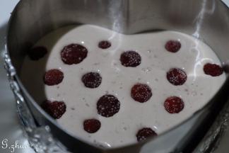 再把一半慕斯液倒入铺入了底层蛋糕片的模具中，（如果有树莓可以再加入颗粒树莓）