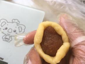 包裹上凤梨馅，一点点用虎口向上推面团，收好收口
