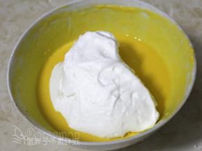 取1/3的蛋白霜加入到蛋黄糊中，用橡皮刮刀用翻拌的手法拌匀。