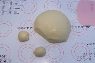 取出面团，检测面团状态，切一小块面团搓圆，静置一下