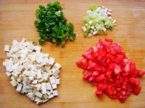 豆腐、西红柿放在砧板上分别切小丁，香葱、葱切碎末。