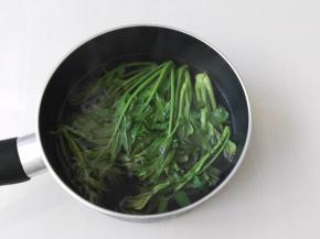 锅里倒入水烧开，然后把香椿放进去焯烫一分钟，叶子变绿就可以了，香椿为什么要焯水呢，因为香椿里含有亚硝酸盐，经过焯烫亚硝酸盐含量大大降低，对身体的伤害也降到最低了。还有一个方法可以一年四季吃到香椿芽，就是焯烫之后晾凉把水分挤一下，然后装进保鲜袋放入冰箱冷冻，便随时可以吃了，拿出来解冻洗一下即可食用。