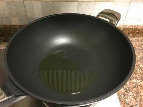 热锅倒油烧至八成热。