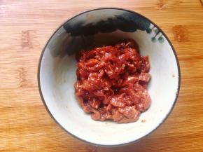 将牛肉洗净切丁，加入少许红薯淀粉、老抽和料酒搅匀，再加入少许油腌制片刻。