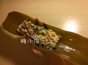 取一张处理好的粽叶，将拌好的米料铺在中间偏上的位置
（干粽叶提前处理，泡软洗净煮过，剪去硬梗部分，煮3-5分钟备用，具体可参见旧文）