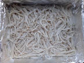 金针菇用水焯一下，捞出平铺在烤盘上。