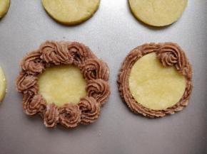 用花嘴在任意处起头，沿顺时针画圈，边旋转花嘴边挤出面糊，形成一个个小的“？”形，如此环绕一圈。