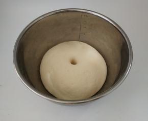 盖上湿布，将其发酵至两倍大。用手指戳个小孔不会回缩。撕开里面有明显的蜂窝状。
