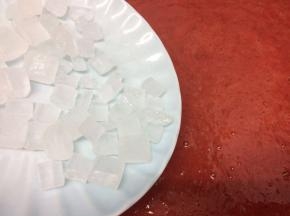 然后把草莓泥放入不粘锅中，再加入冰糖小火慢慢熬制，熬到比较粘稠为止