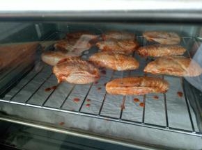 从冰箱拿出鸡翅来，烤网上刷一层油，鸡翅摆上去，烤箱200度预热好后烤15分钟，翻面再烤15分钟（下面垫一个烤盘用来接油，这样好清理烤箱）