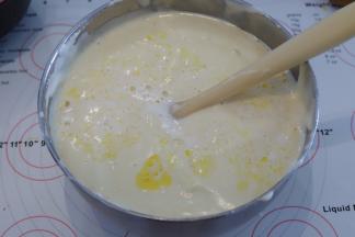 隔刮刀倒入黄油牛奶混合物，同样翻拌的手法混合蛋糕糊，面糊呈现细腻光滑的丝绸状