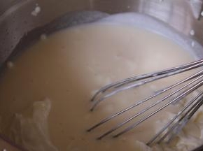 打发至六分状态可以流动的状态。然后将慕斯液分出235克，120克的两份