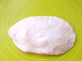 取出倒在揉面垫上按压排气