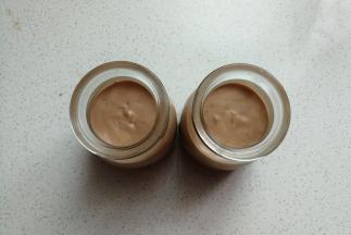 接着把巧克力慕斯糊均分到两个布丁杯中，然后放入冰箱冷藏至凝固。