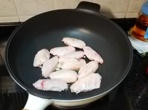 锅里放油、蒜片爆香，放入鸡翅