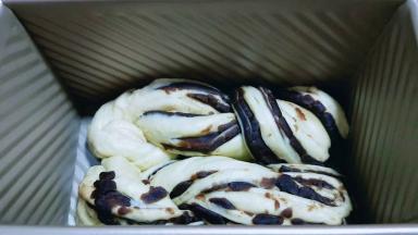 把两块面团依次做完，放模具中，入烤箱进行二发，可以放入一碗开水，二发一定要保持面团的湿度。（我的吐司盒是450g）