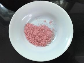 然后取一小把米粉，加入少许的红色果粉拌匀。