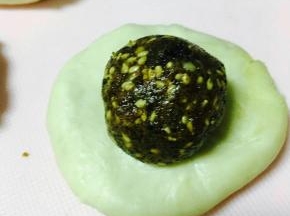 擀成圆形，放馅儿料，包好。