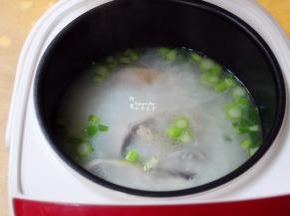 粥煮好了，开盖子，加入鱼块、菜心根，用勺子再锅里拌均一下，煮至八成熟。