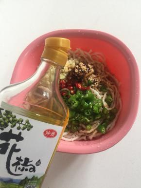 牛筋面里加入蒜末，青尖椒圈，红尖椒圈，味极鲜酱油，香醋，盐，香油，鸡精和仲景花椒油。