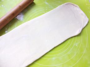 撒点干粉，再将将面片擀长，长度同样为50厘米左右