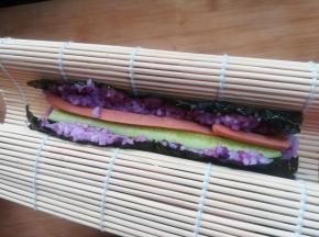 9 用手托起卷帘，让两端粘合在一起。因为米饭有粘性，会很自然的粘合在一起。