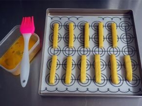 将其摆放到烤盘上，表面刷上一层全蛋液。