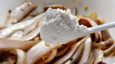 腌制好加面粉裹上每一条凤尾鱼。