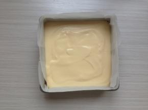 拌好的蛋糕糊倒入到铺了油纸的，18CM方型模具里。震动一下烤盘，使蛋糕糊里的大气泡震出来