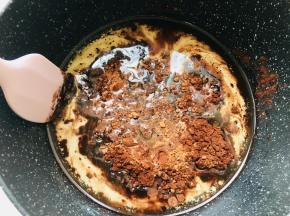 将可可粉倒入加热后的牛奶玉米油中，搅拌均匀