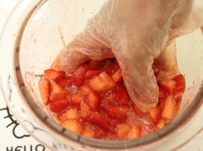 带上一次性手套，将草莓和砂糖拌匀，一边拌一边捏碎
