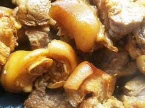 热锅放油，小火炒冰糖至糖色，放入猪蹄翻炒。