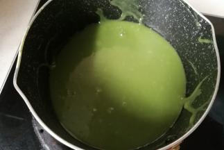 按下来再来做慕斯糊，慕斯糊做的两种颜色两种口味：先把抹茶粉放入牛奶中搅打均匀，再把牛奶倒入奶锅中加入白巧克力小火加热融化，边加热边搅拌，待巧克力完全融化后关火晾凉。