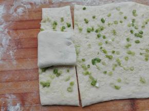 将上面折叠好的向右侧方向，正好在中间位置折叠过去，然后同样用刀在其两端切开，按照我们折叠的面片来切即可。